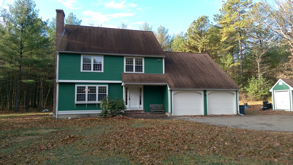 82 Walker Road Shirley, MA 01464 - Photo 1 of 27 a front view of a house with a garden and garage