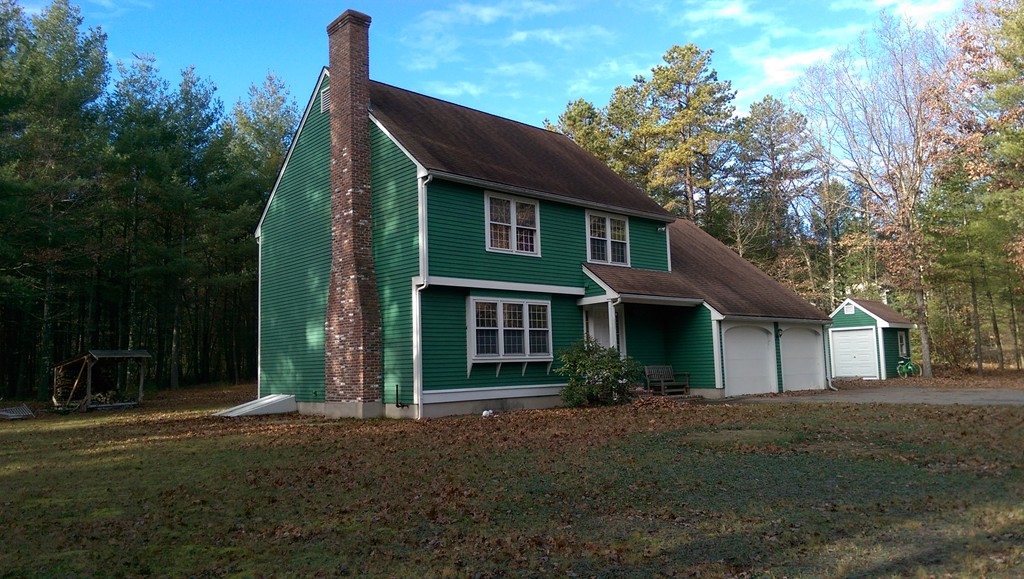 82 Walker Road Shirley, MA 01464 - Photo 2 of 27 a front view of a house with a yard and garage