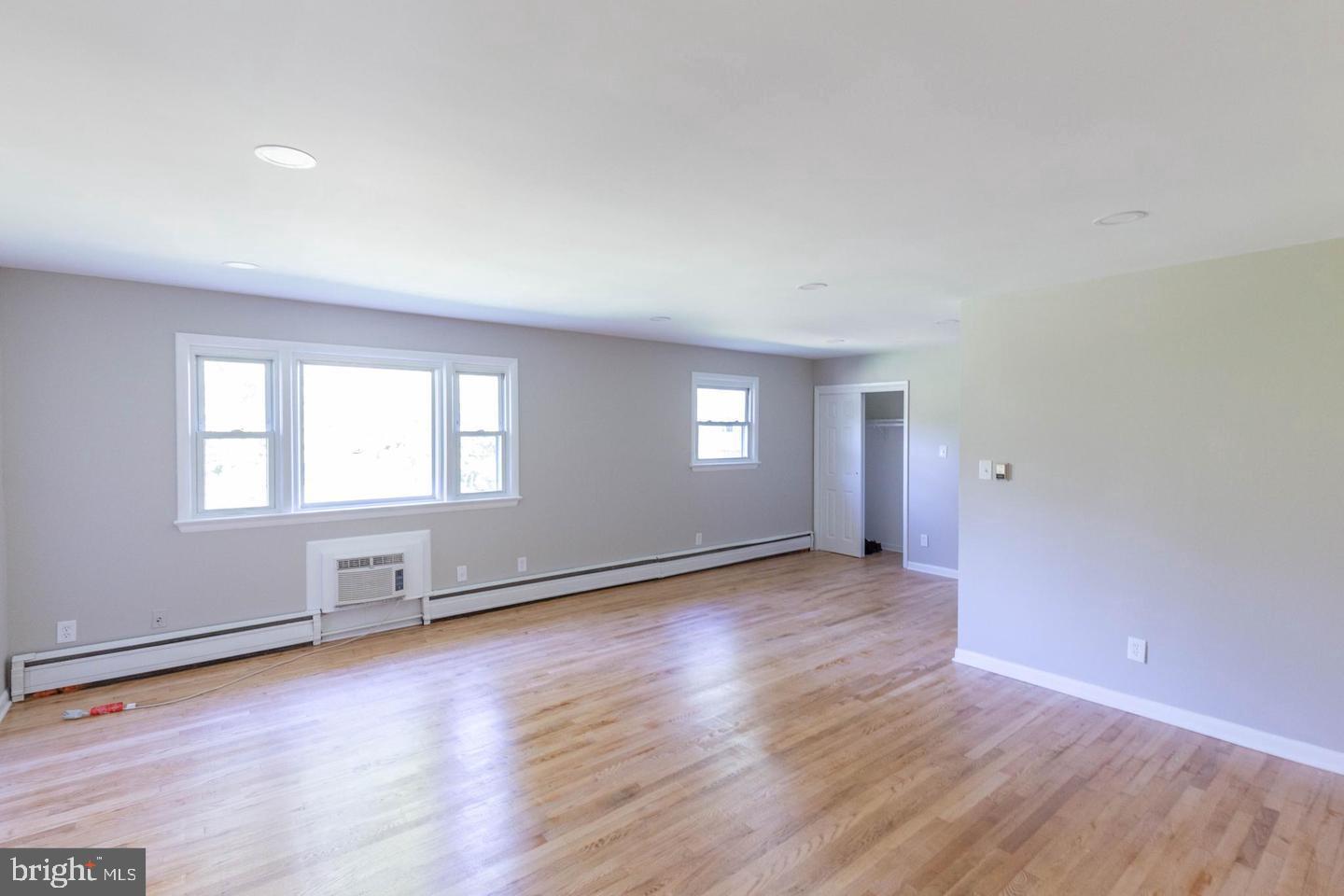 14698 Colchester Road Woodbridge, VA 22191 - Photo 4 of 15 an empty room with wooden floor and windows