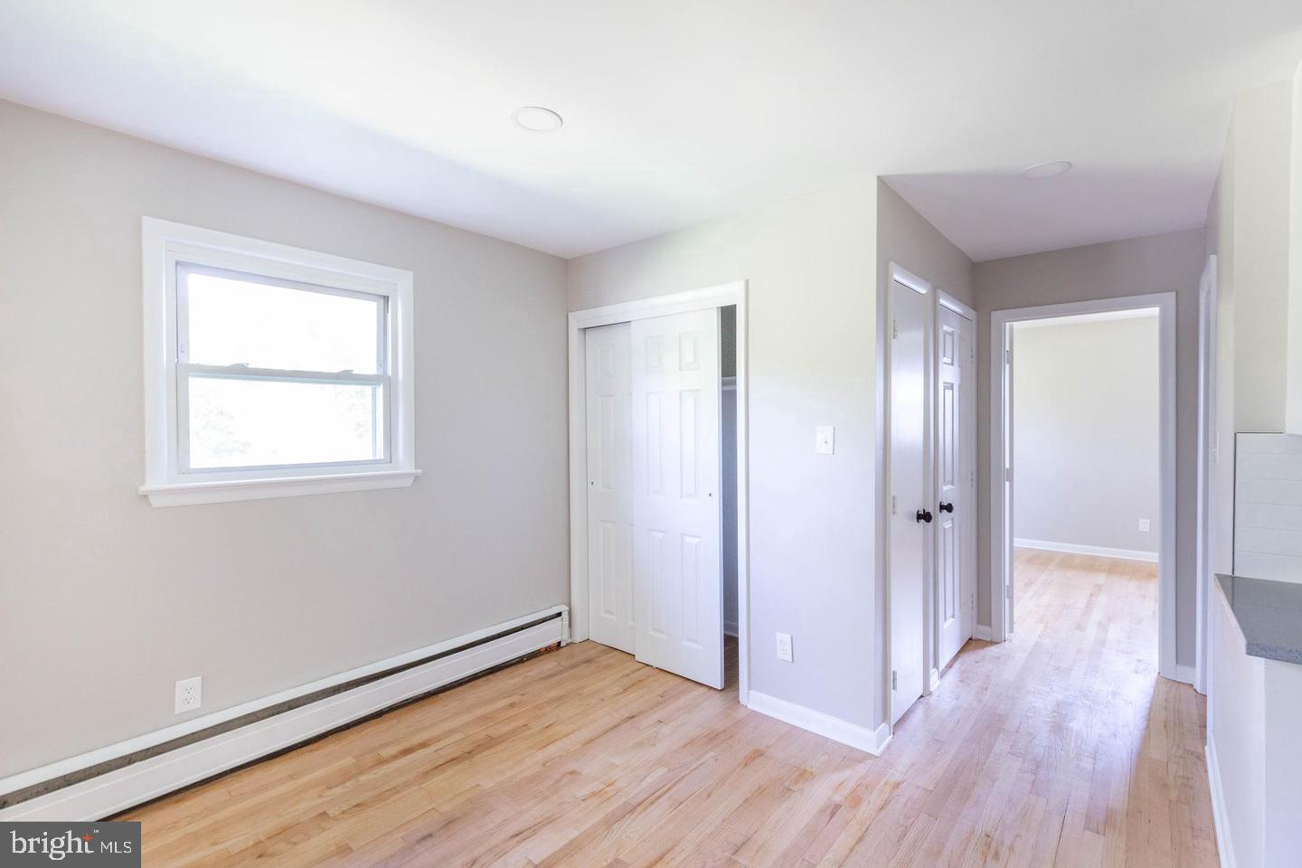 14698 Colchester Road Woodbridge, VA 22191 - Photo 6 of 15 a view of an empty room with wooden floor and a window