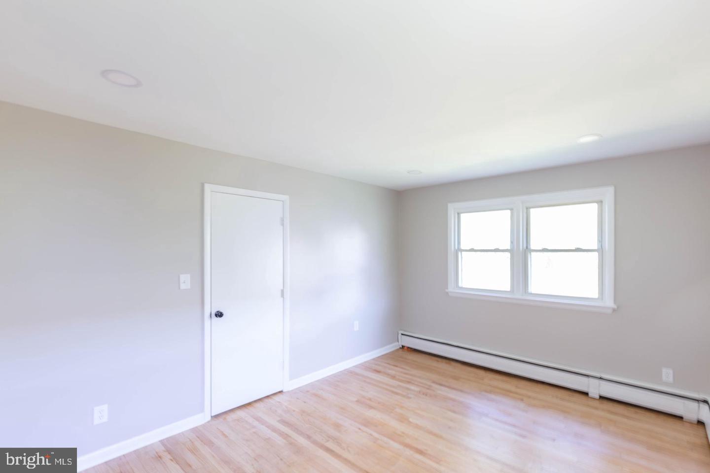 14698 Colchester Road Woodbridge, VA 22191 - Photo 9 of 15 an empty room with wooden floor and windows