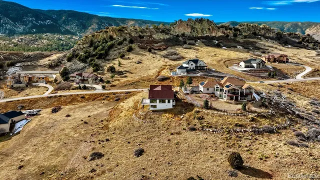 an aerial view of a house with pool and deck