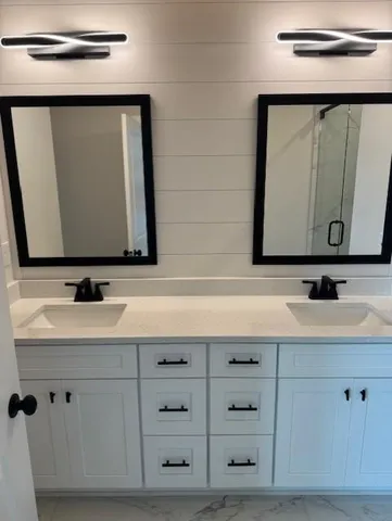 a bathroom with a sink vanity and mirror