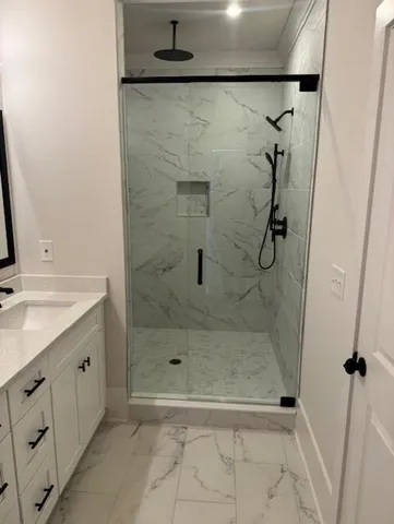 a bathroom with a shower and a sink