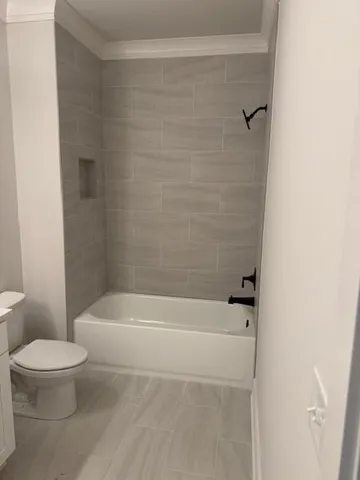 a bathroom with a toilet and a bath tub