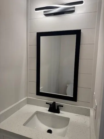 a bathroom with a sink and a mirror