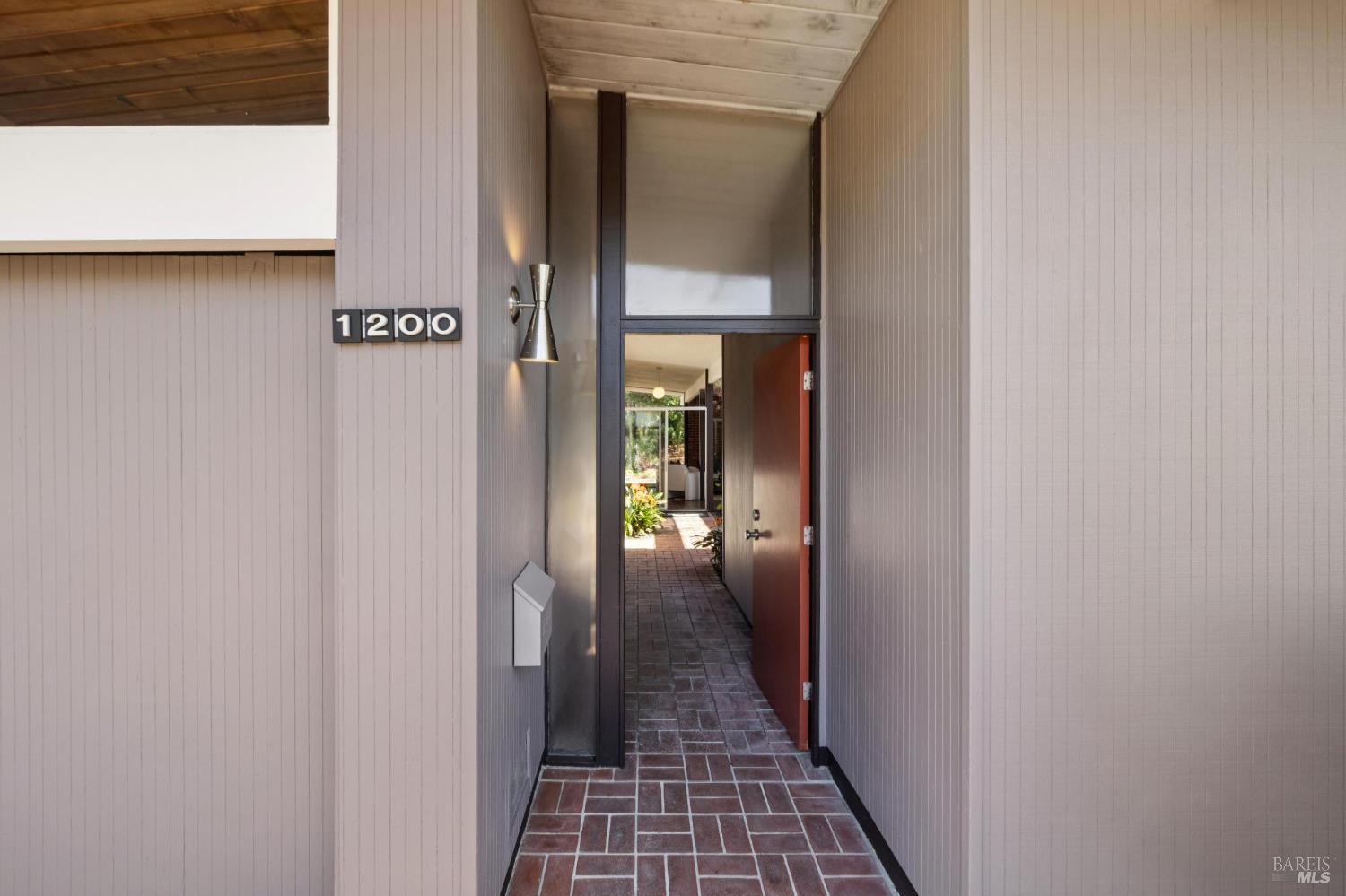 1200 Idylberry Road San Rafael, CA 94903 - Photo 9 of 58 a view of a hallway with wooden floor and a bathroom