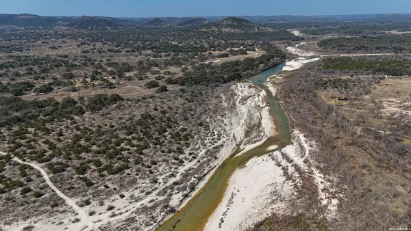 a view of a dry yard with wooden floor and mountain view