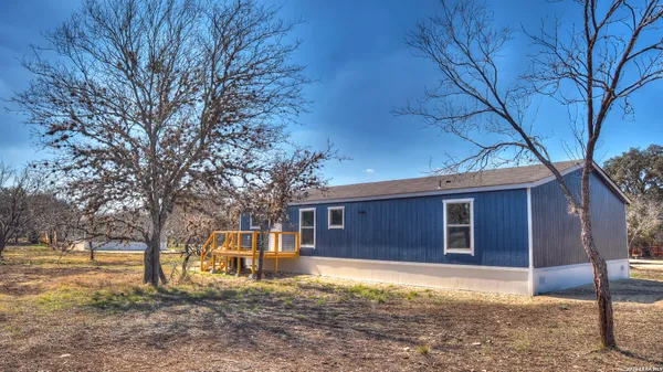 a view of a yard covered with snow in front of house