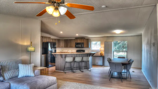 a view of a dining room with furniture window and wooden floor