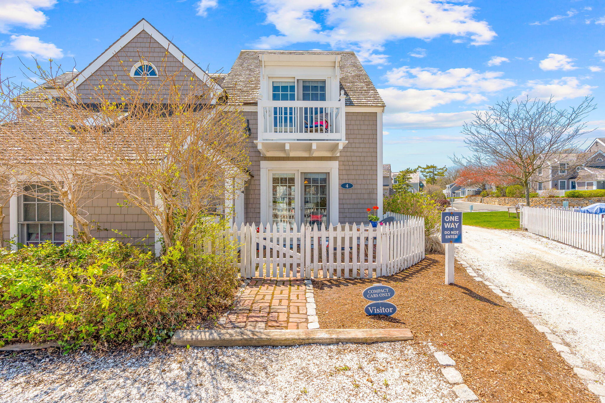 4 Race Point Road, Unit 4 Mashpee, MA 02649 - Photo 8 of 43 a front view of a house with a garden
