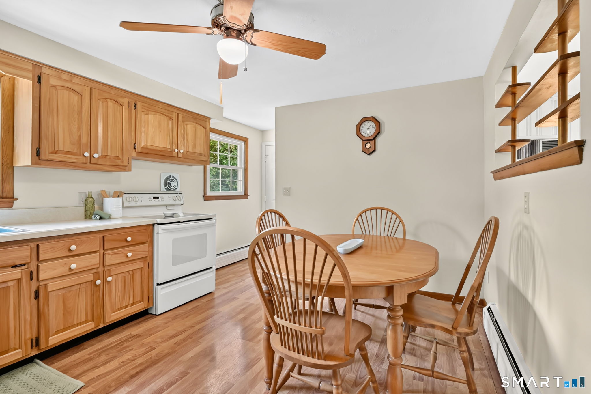 296 Phoenix Street Vernon, CT 06066 - Photo 6 of 34 a kitchen with stainless steel appliances granite countertop a dining table chairs and a refrigerator