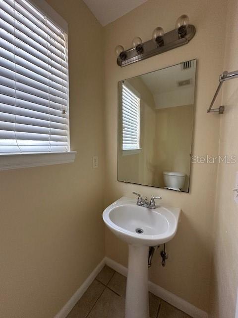 3031 Southwest Archer Road, Unit 2A Gainesville, FL 32608 - Photo 3 of 10 a bathroom with a sink and a mirror