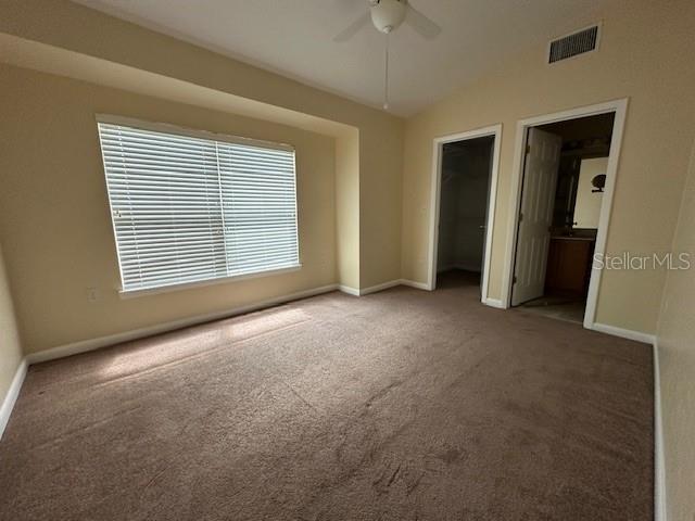 3031 Southwest Archer Road, Unit 2A Gainesville, FL 32608 - Photo 6 of 10 an empty room with closet and a ceiling fan