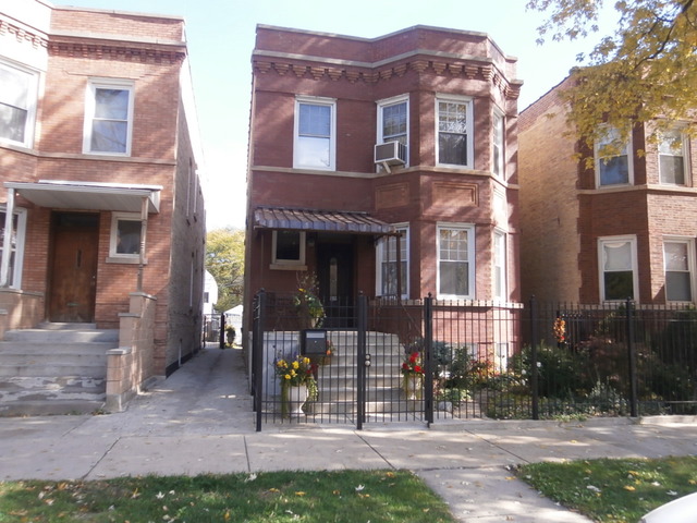 3137 North Ridgeway Avenue, Unit 1 Chicago, IL 60618 - Photo 1 of 1 a front view of a building with a garden
