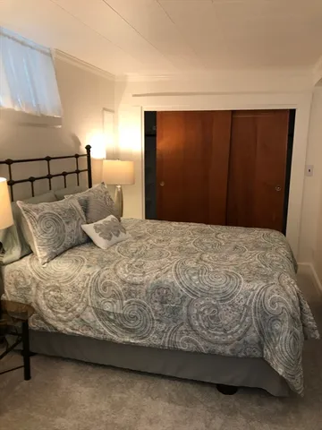 a bedroom with a bed and a mirror