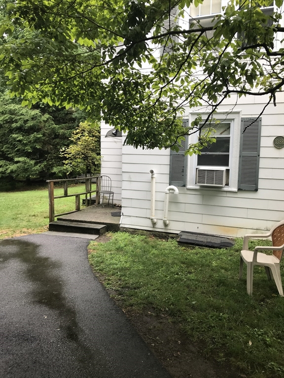 138 R Weston Road, Unit 138R Wellesley, MA 02482 - Photo 15 of 16 a view of a house with backyard and a garden