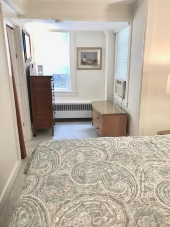 a bedroom with a bed furniture and a large window