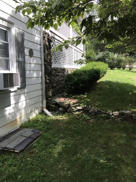 138 R Weston Road, Unit 138R Wellesley, MA 02482 - Photo 10 of 16 a view of a house with a yard