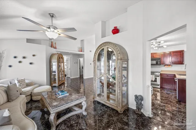 a living room with furniture a chandelier and a flat screen tv