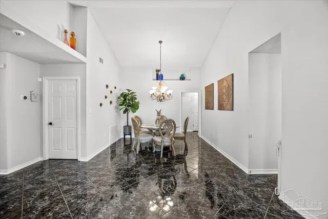 a dining room with furniture and chandelier