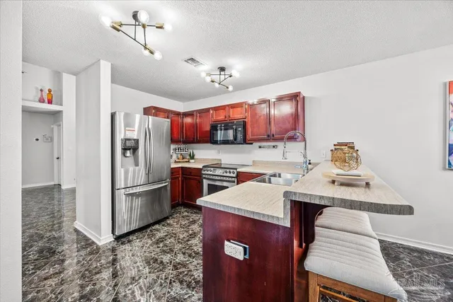 a kitchen with refrigerator cabinets and wooden floor