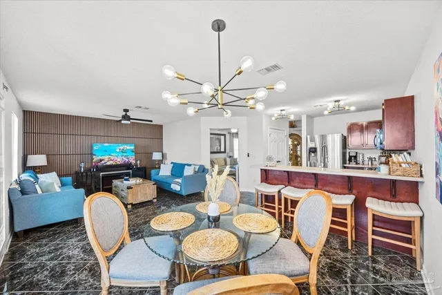 a dining room with furniture and a chandelier