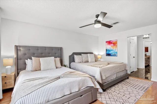 a bedroom with double bed and a chandelier