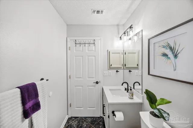 a bathroom with a sink a toilet and mirror