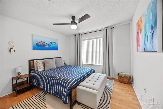 a bedroom with a large bed and a chandelier