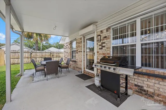 a dining room with furniture and a floor to ceiling window