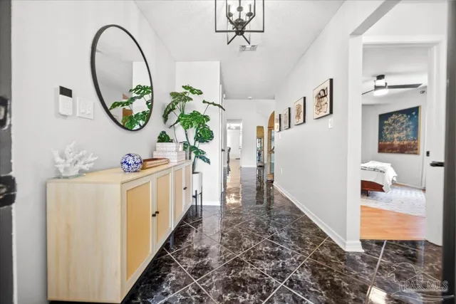 a view of living room with furniture and a mirror
