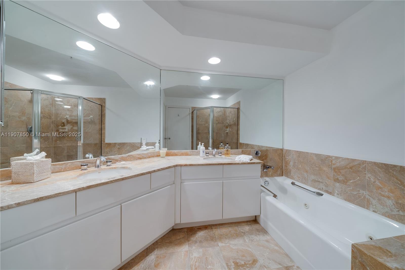888 Brickell Key Drive, Unit 2610 Miami, FL 33131 - Photo 14 of 37 a spacious bathroom with a granite countertop sink mirror and bathtub