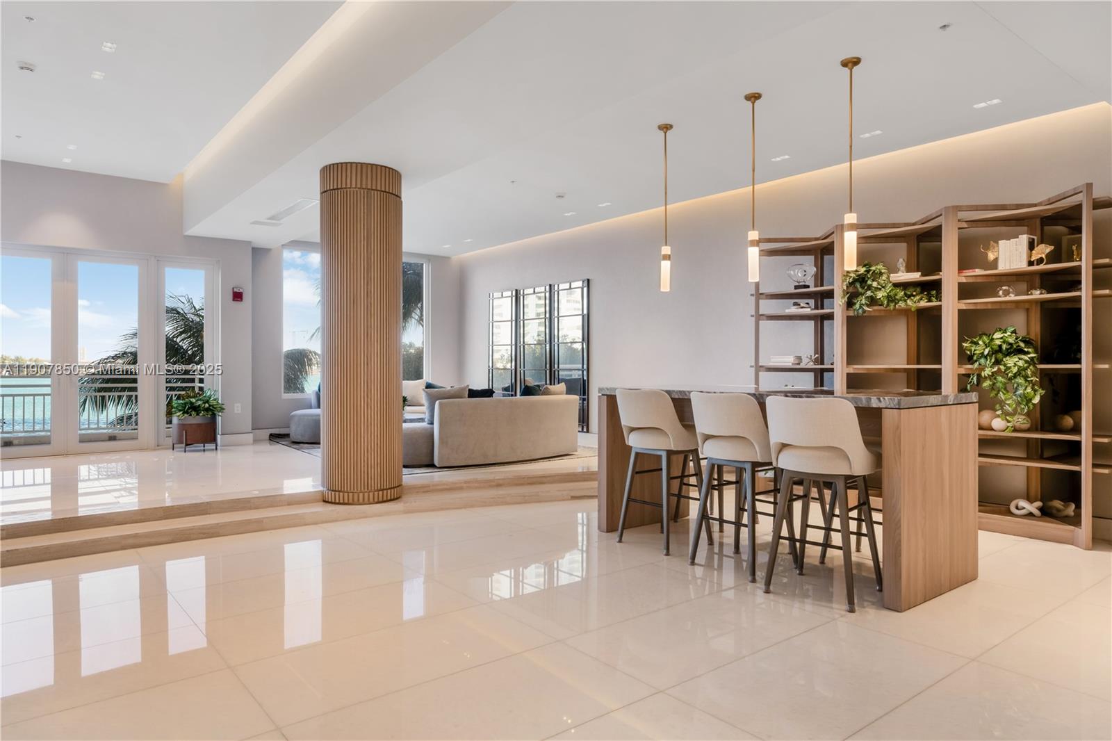 888 Brickell Key Drive, Unit 2610 Miami, FL 33131 - Photo 28 of 37 a open kitchen with stainless steel appliances kitchen island granite countertop a table chairs and a view of living room