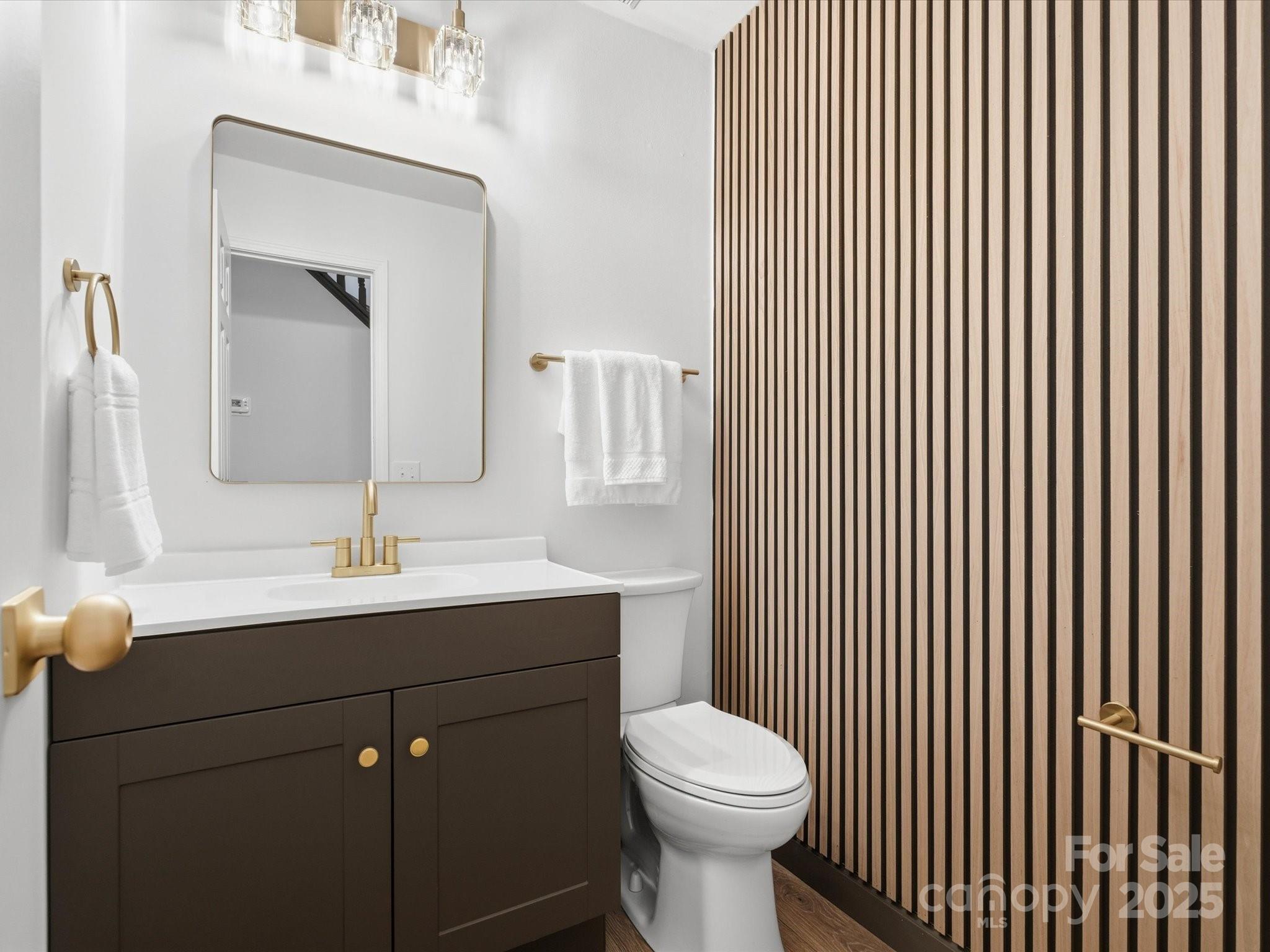 3909 Brownes Ferry Road Charlotte, NC 28269 - Photo 14 of 47 a bathroom with a toilet a sink and mirror