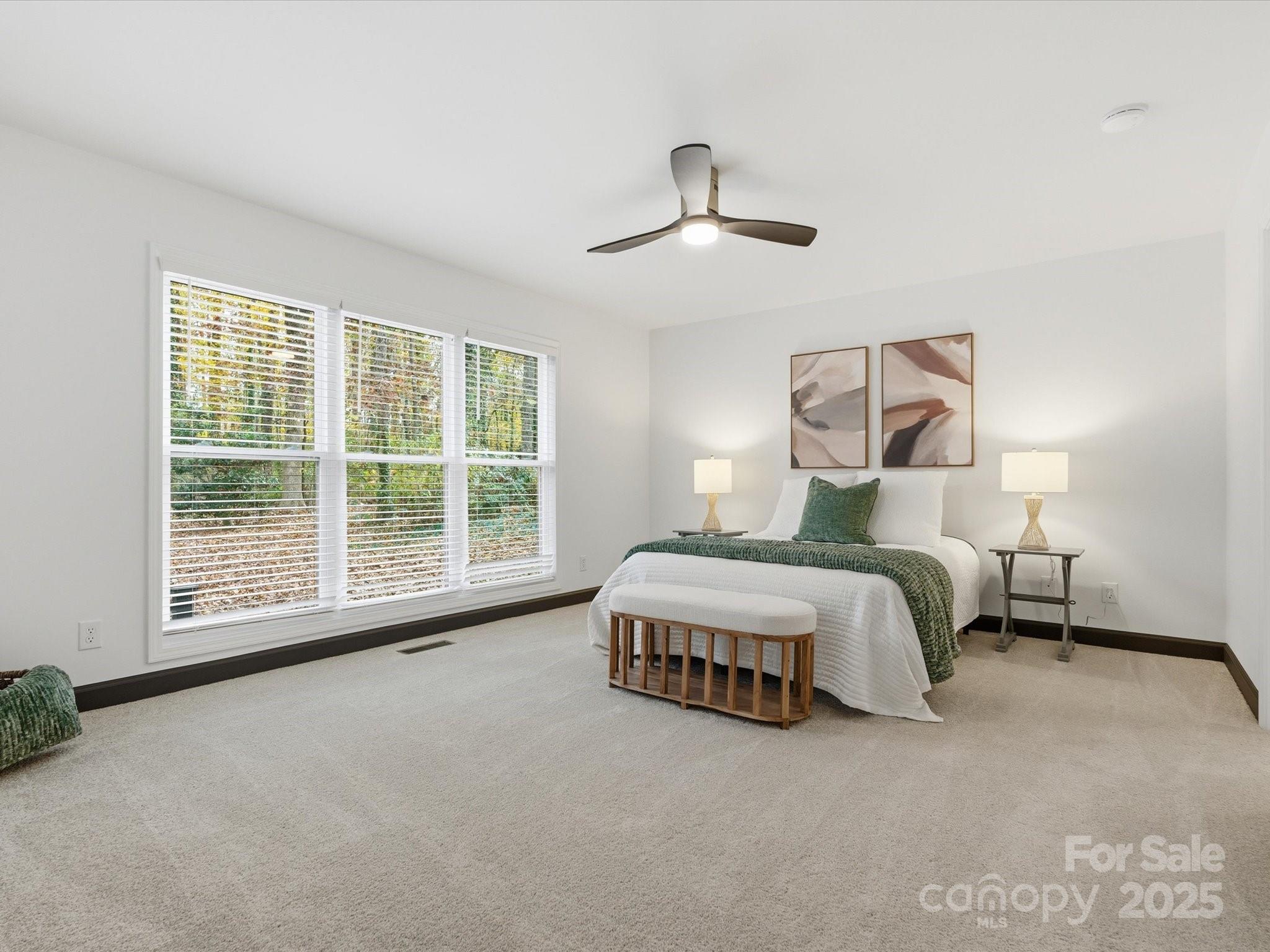 3909 Brownes Ferry Road Charlotte, NC 28269 - Photo 16 of 47 a spacious bedroom with a bed and a large window