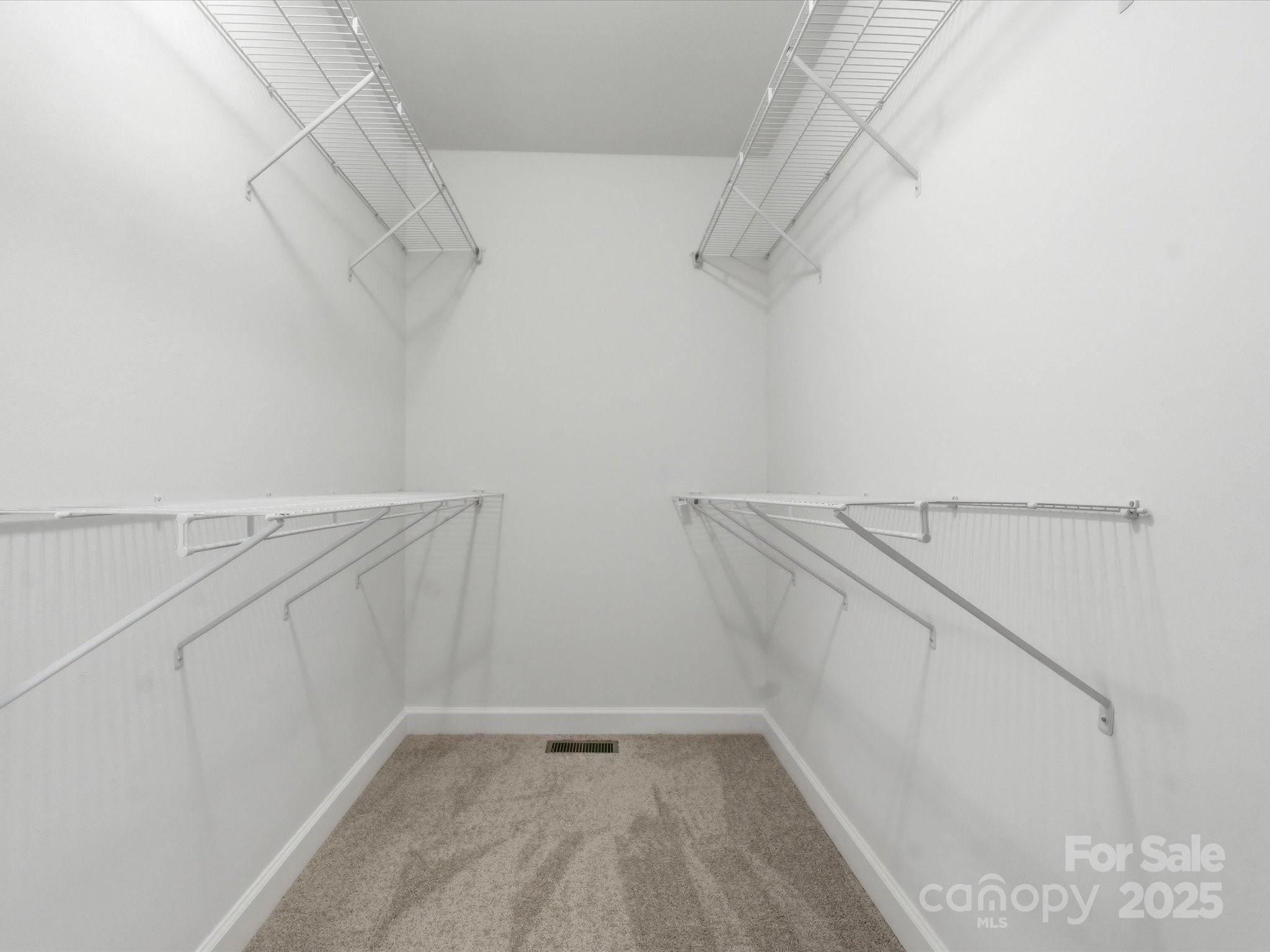 3909 Brownes Ferry Road Charlotte, NC 28269 - Photo 23 of 47 a view of walk in closet with empty racks