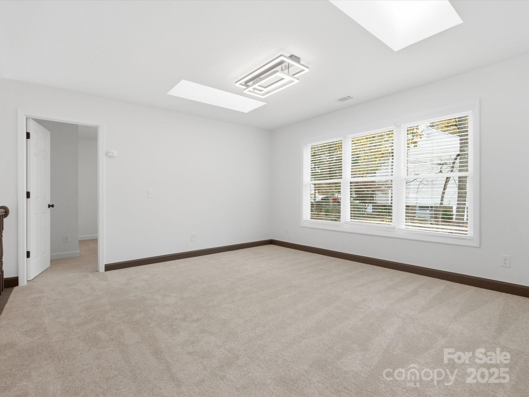 3909 Brownes Ferry Road Charlotte, NC 28269 - Photo 28 of 47 an empty room with windows