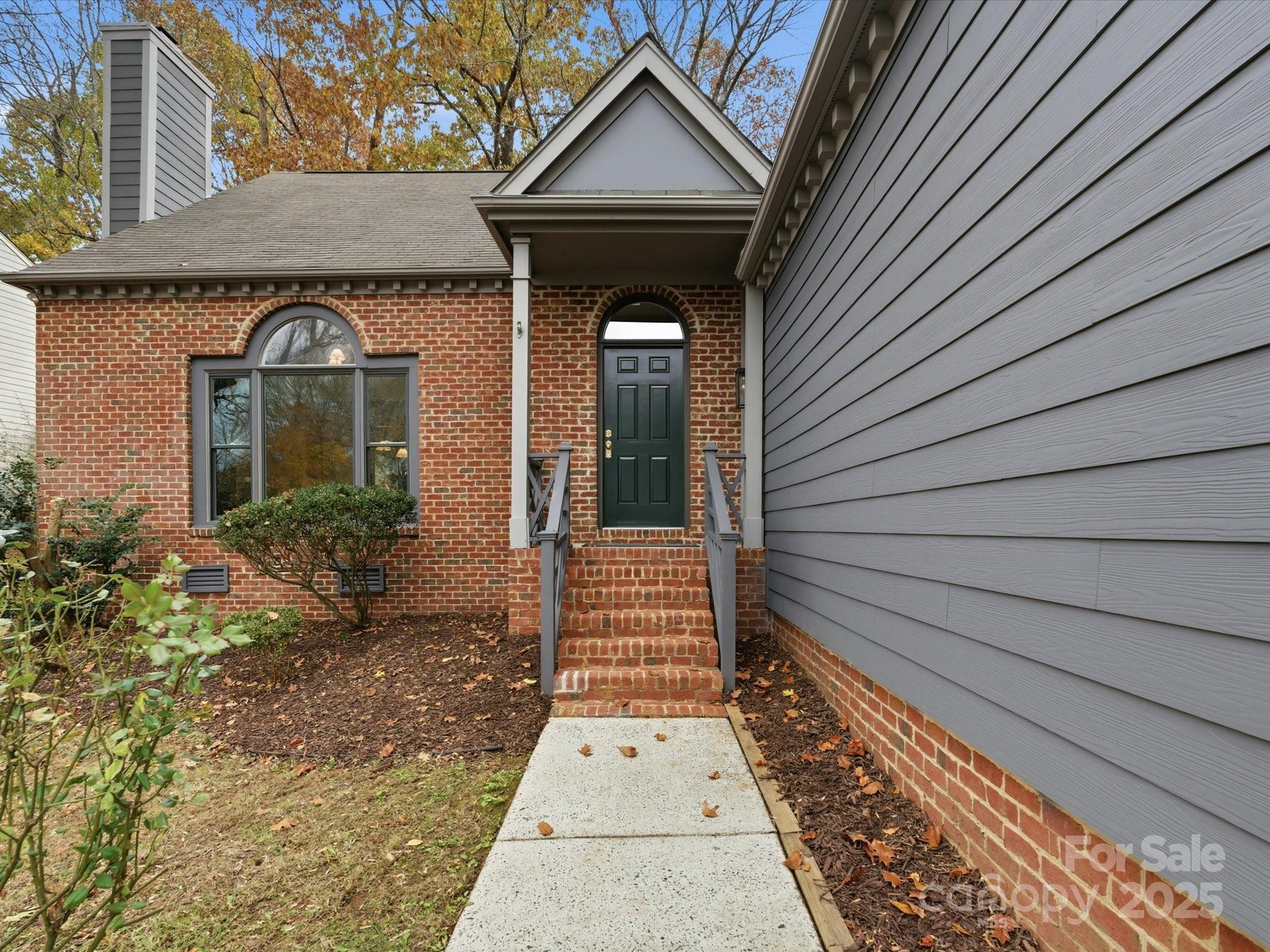3909 Brownes Ferry Road Charlotte, NC 28269 - Photo 3 of 47 a front view of a house with a garden