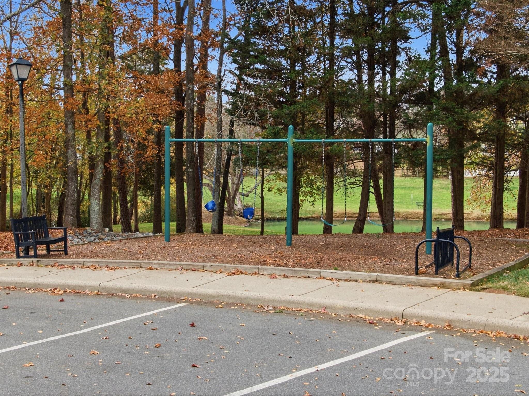 3909 Brownes Ferry Road Charlotte, NC 28269 - Photo 46 of 47 a view of a park with swings and slides