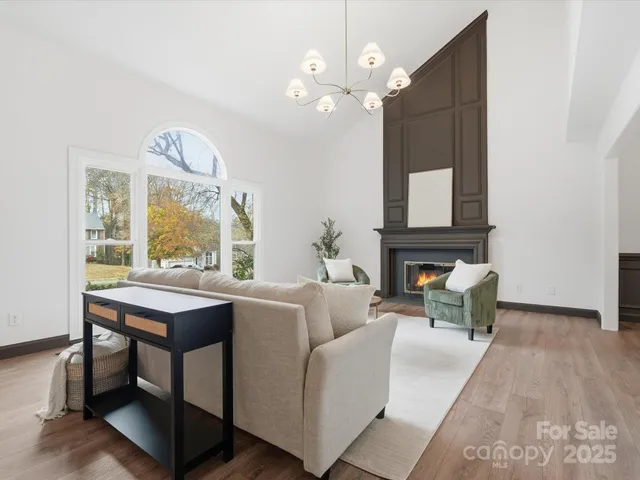 a living room with furniture a fireplace and a table