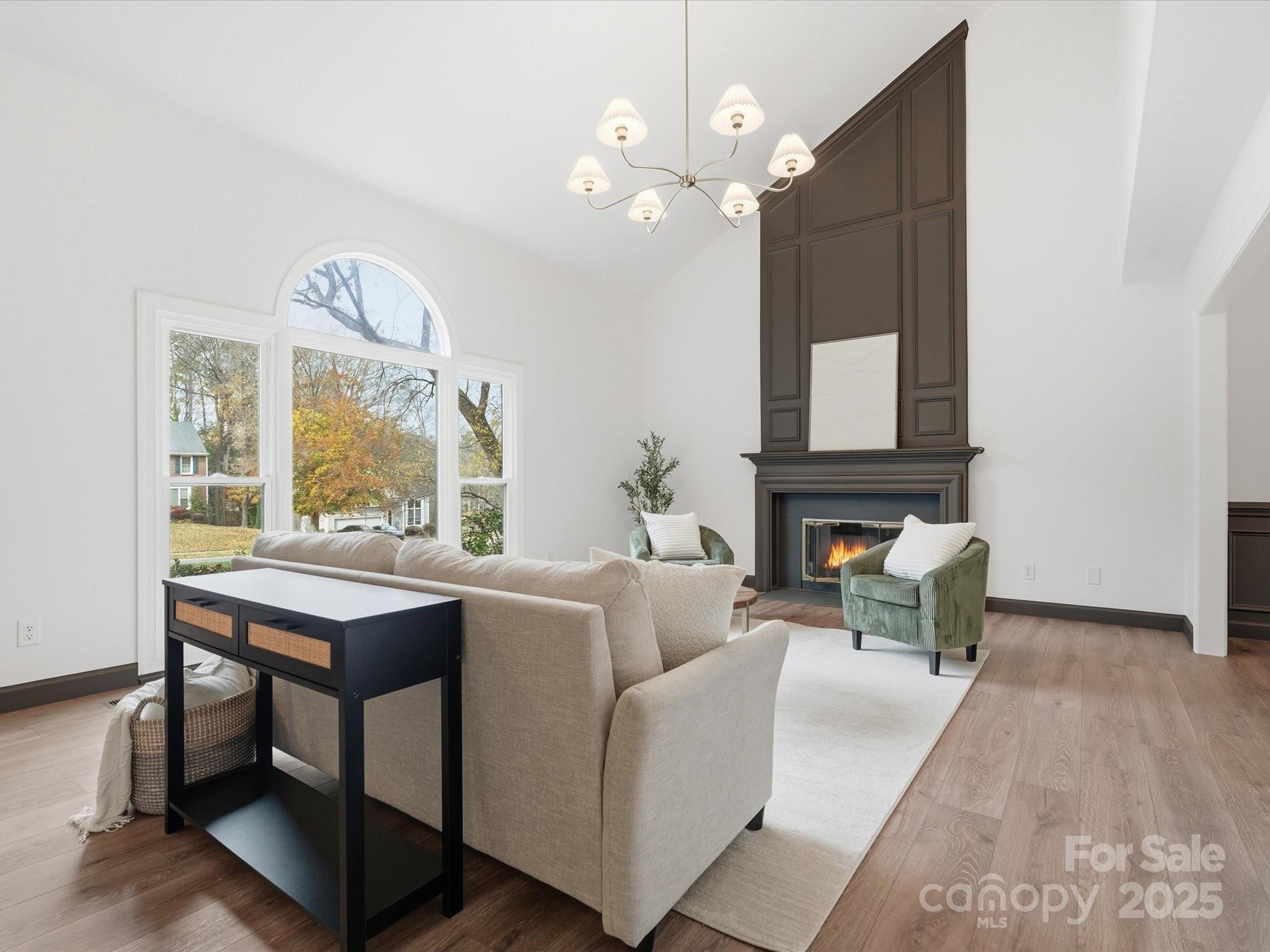 3909 Brownes Ferry Road Charlotte, NC 28269 - Photo 5 of 47 a living room with furniture a fireplace and a table