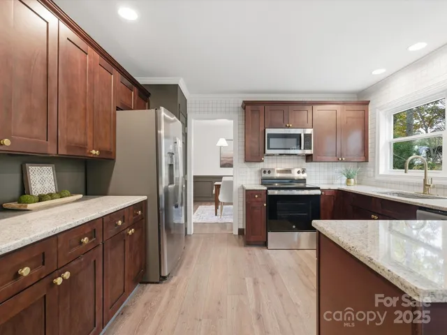 a kitchen with a sink stove and refrigerator