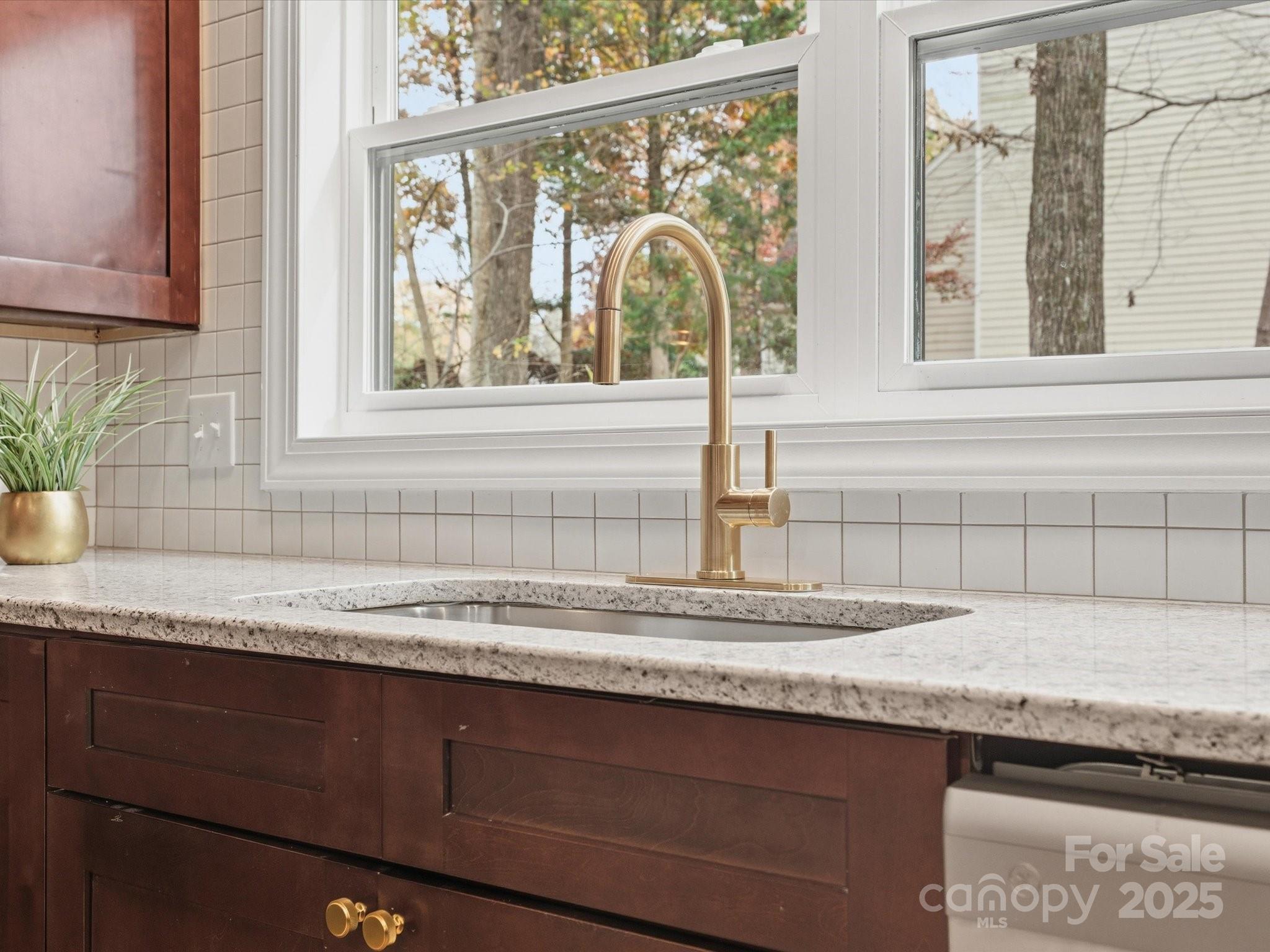 3909 Brownes Ferry Road Charlotte, NC 28269 - Photo 10 of 47 a kitchen with granite countertop a sink and a window