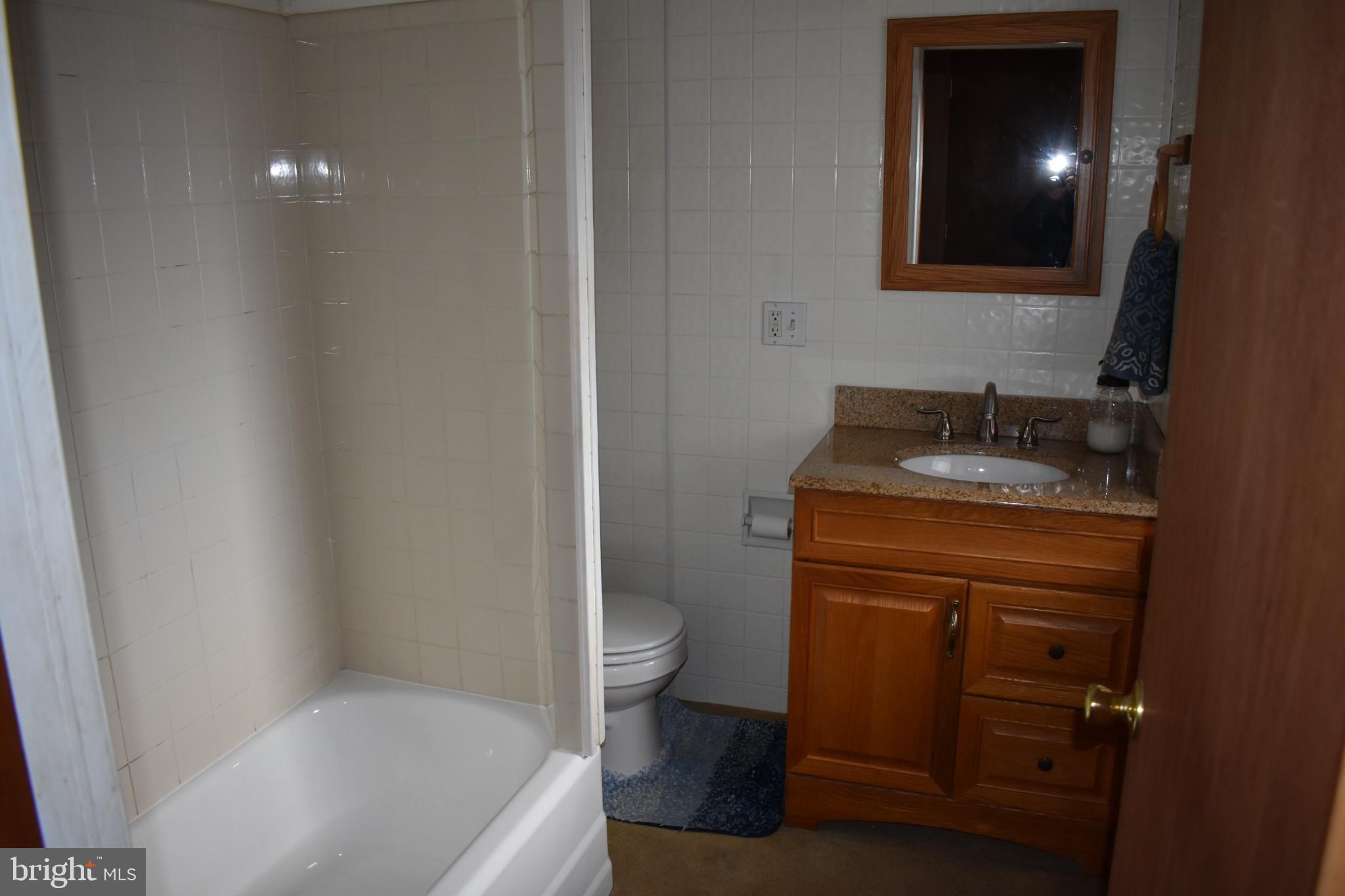 409 Walnut Street West Reading, PA 19611 - Photo 12 of 24 a bathroom with a granite countertop sink toilet and shower