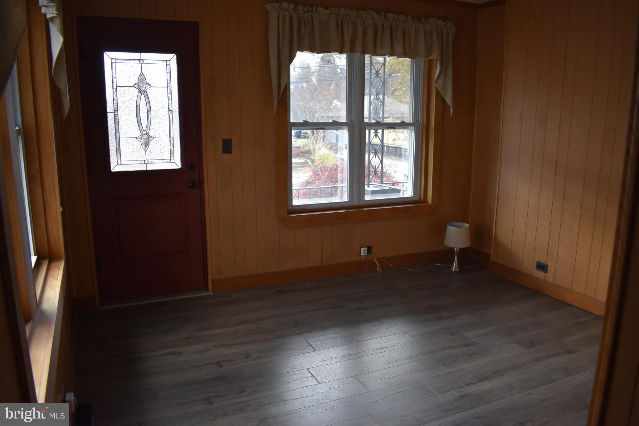 409 Walnut Street West Reading, PA 19611 - Photo 5 of 24 an empty room with wooden floor and windows