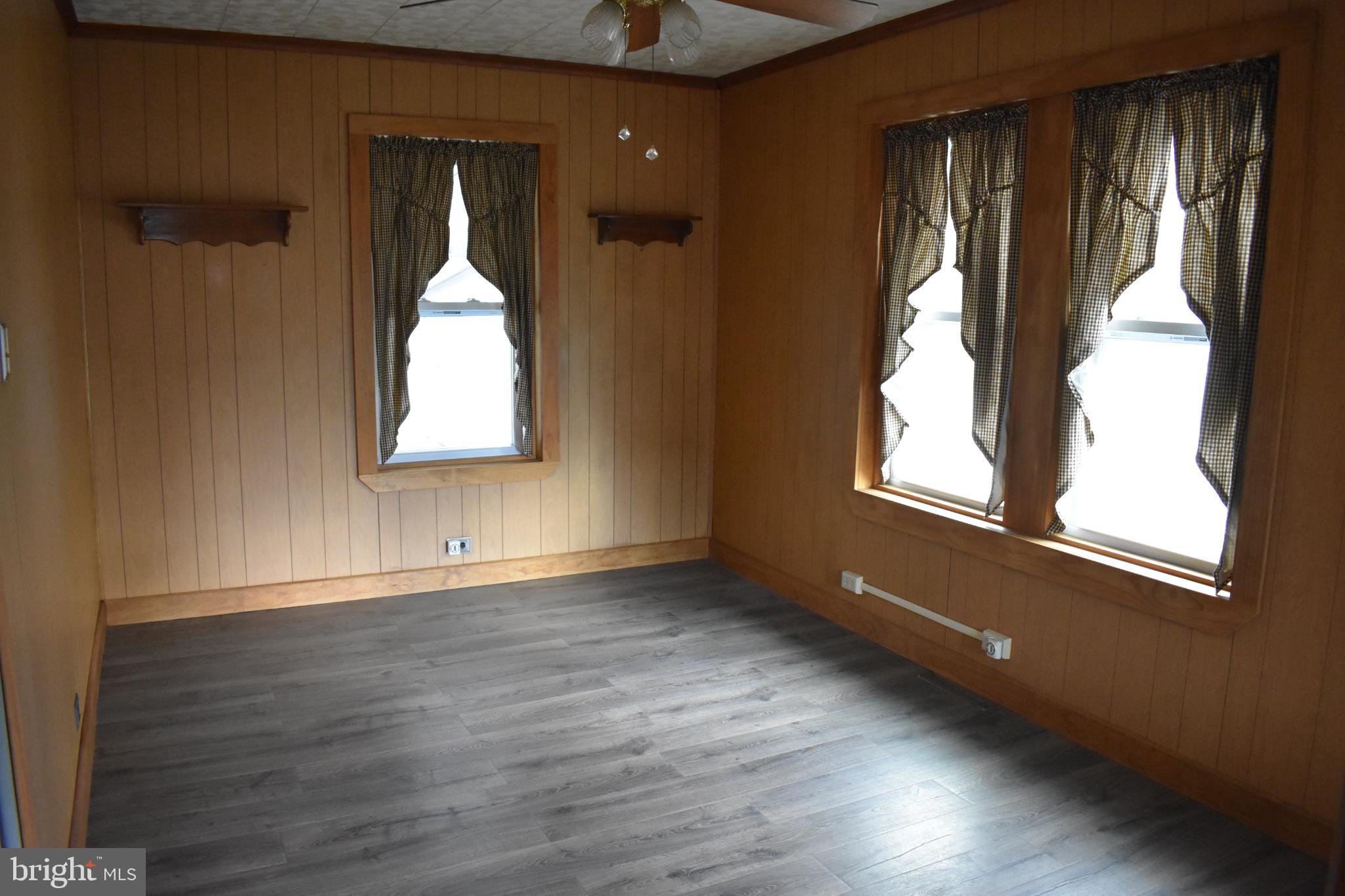 409 Walnut Street West Reading, PA 19611 - Photo 6 of 24 an empty room with wooden floor and windows