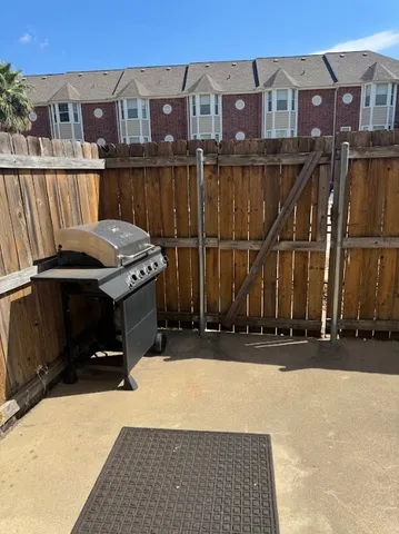 a view of a brick house with a small yard