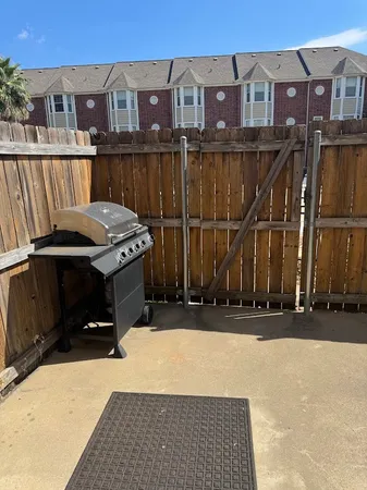 a view of a brick house with a small yard