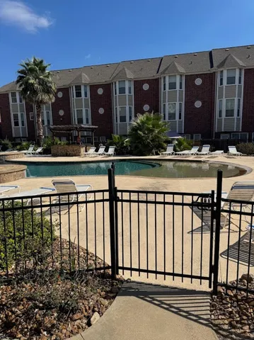 a view of a brick house next to a yard
